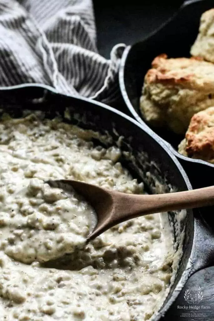 sausage gravy with heavy cream in a cast iron skillet