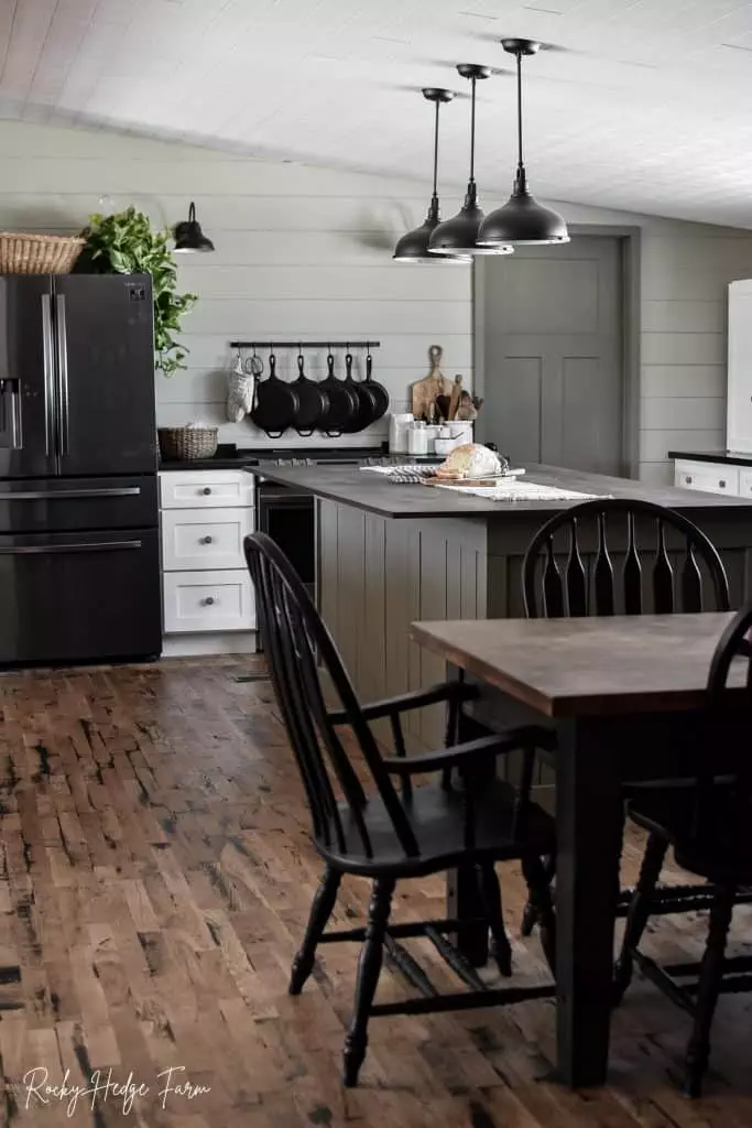 A kitchen with a shiplap wall