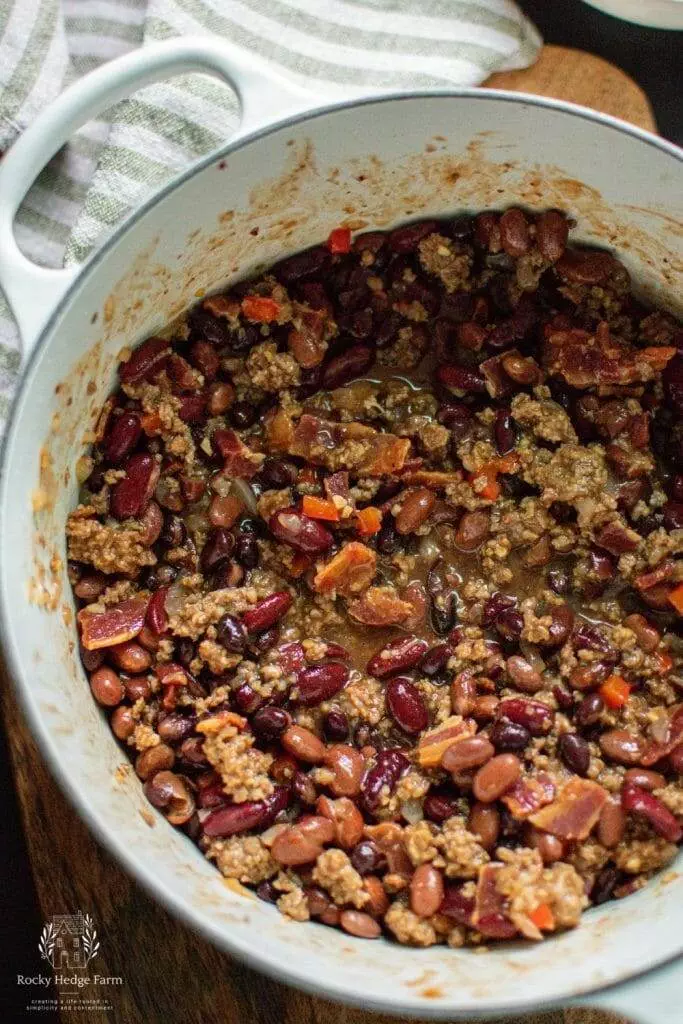 White Dutch Oven Filled with Delicious Cowboy Beans