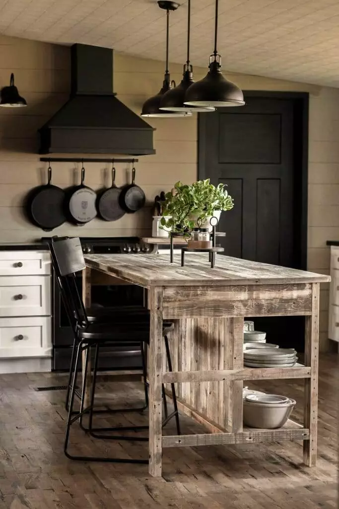 Vintage kitchen island featuring a reclaimed wood top, breakfast bar with seating for two, and spacious shelves and drawers for organized storage.