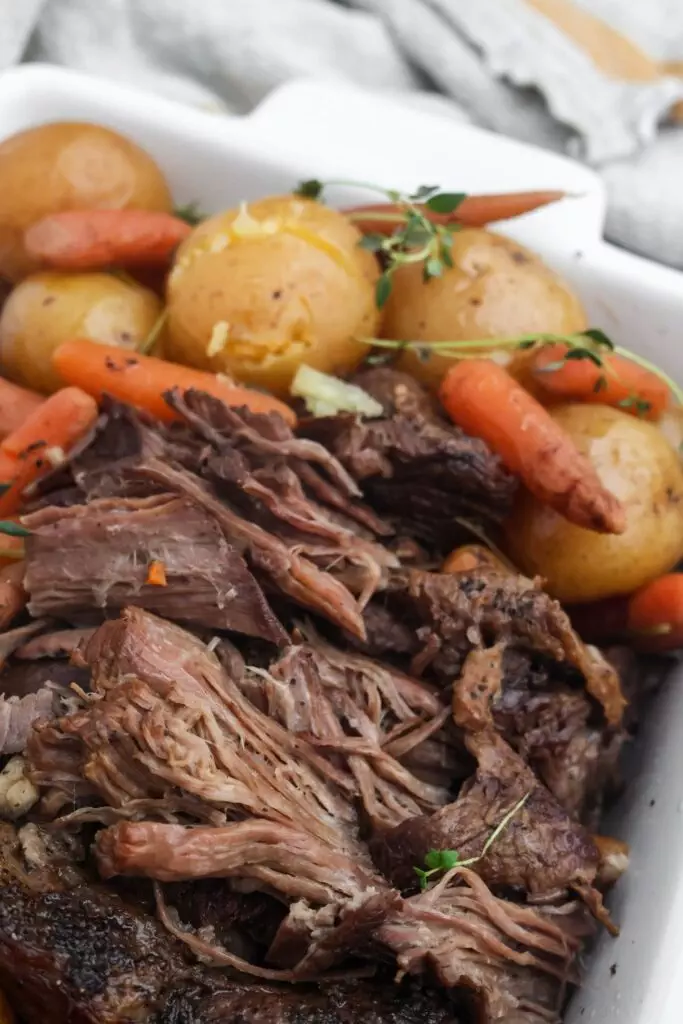 Close-up of shredded beef roast with carrots and potatoes