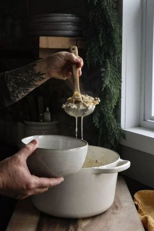 Rich and creamy Italian sausage soup being ladled into a bowl